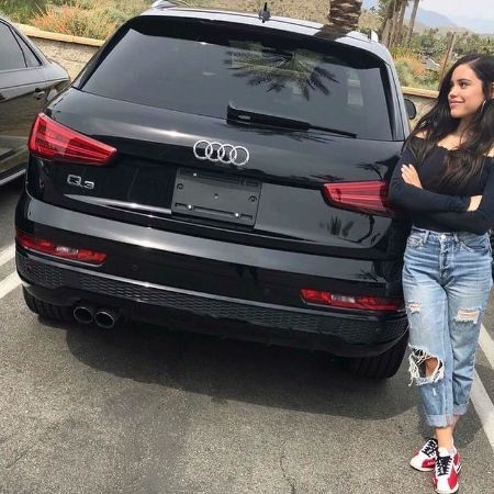 Jenna Ortega took a picture next to her Audi. 